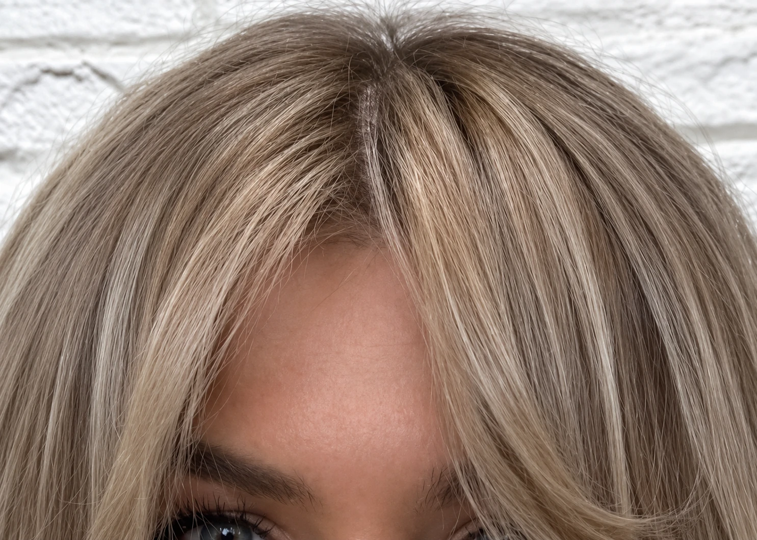 Close-up of a soft blonde fringe framing the forehead